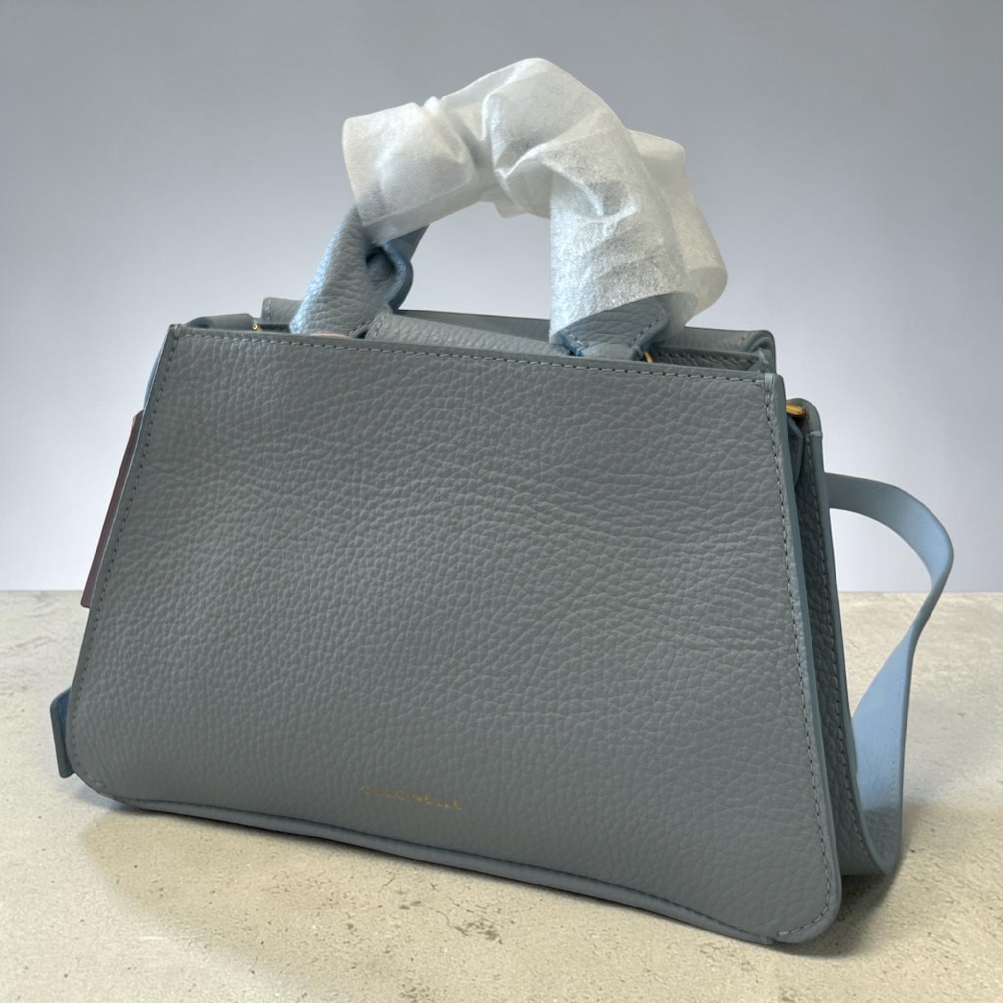Skórzana Torebka Kuferek Coccinelle Talea Mini – Błękitna (Denim Blue)